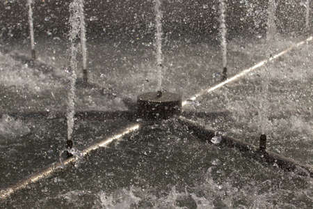splashing water fountain on a sunny day