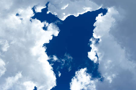 Blue sky background with cloudsの写真素材