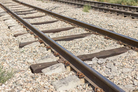 Railroad in motion at sunset. Railway station with motion blur effect against colorful blue sky,...