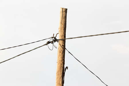 Electrical pole and wires against the sky