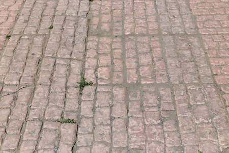 Stone pavement texture. Granite cobblestoned pavement background. Abstract background of old...