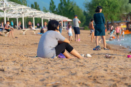 beach, mum watches the children when they swimの写真素材