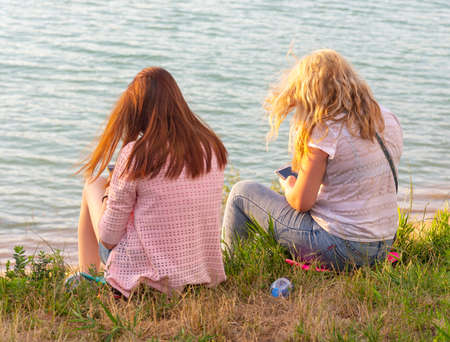 the girl sits on the beachの写真素材