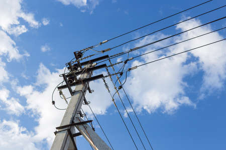 Electrical pole and wires against the sky