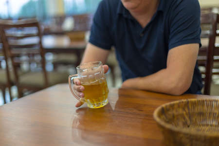 man holding a mug of beerの写真素材