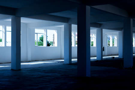 Unfinished interior of business center under construction in grey colours