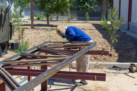 Welder at the factory working with metal constructionの写真素材