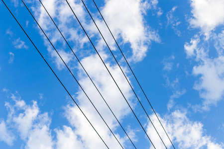 Electrical pole and wires against the skyの写真素材