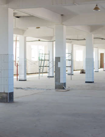 Unfinished interior of business center under construction in grey colours