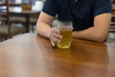 man holding a mug of beerの写真素材