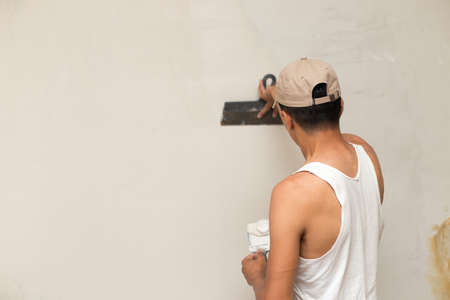 The process of applying the second layer of putty trowel for light plaster wallsの写真素材