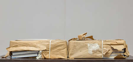 new books wrapped in brown paper on the table
