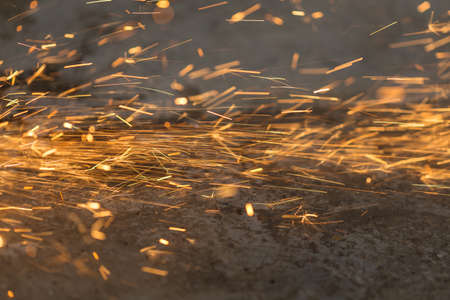 Bright blue and yellow sparks on a black background. Magical ligの写真素材