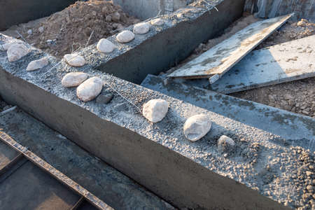 Workers lay the foundation for a new home