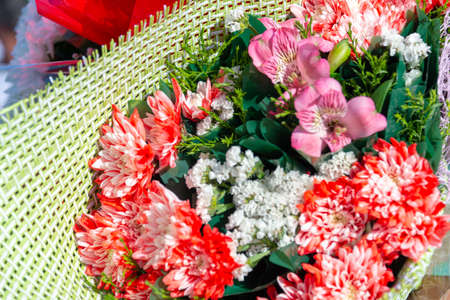 holiday, bouquet of flowers in handsの写真素材