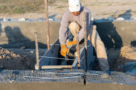 Workers lay the foundation for a new home