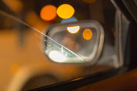 Artistic style - Defocused urban abstract texture ,blurred background with bokeh of city lights from car on street at night, vintage or retro color toneの写真素材