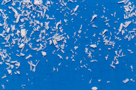 A pile of coconut flakes on a blue background