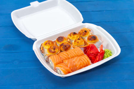 Delicious delicious nigiri sushi, lay on a blue table. Traditional Japanese cuisine, delicious seafood, sushi restaurant conceptの写真素材