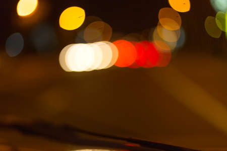 Artistic style - Defocused urban abstract texture ,blurred background with bokeh of city lights from car on street at night, vintage or retro color toneの写真素材