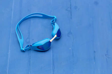 floating glasses on blue wooden backgroundの写真素材