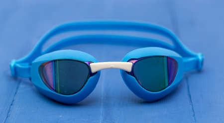 floating glasses on blue wooden backgroundの写真素材