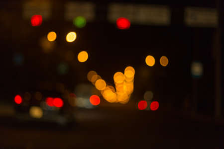 Artistic style - Defocused urban abstract texture ,blurred background with bokeh of city lights from car on street at night, vintage or retro color toneの写真素材