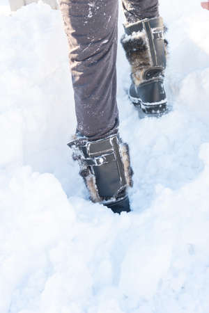 a walk in the snow. closeup of winter shoesの写真素材