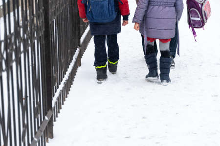 In winter, children return home from school.の写真素材