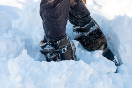 a walk in the snow. closeup of winter shoesの写真素材