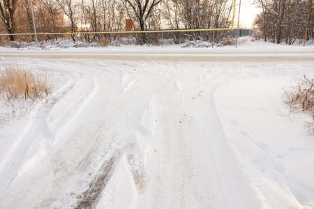 Tire track in the snow to the horizonの写真素材