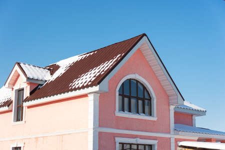 Winter snow on the roofの写真素材
