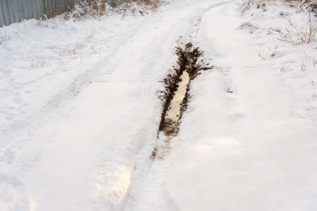 Tire track in the snow to the horizonの写真素材