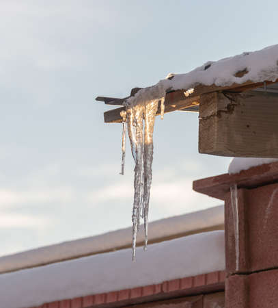 Ice icicles on the roofの写真素材