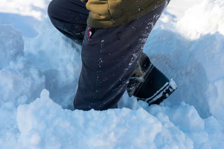 A man walking in the snow. Closeup of winter shoesの写真素材