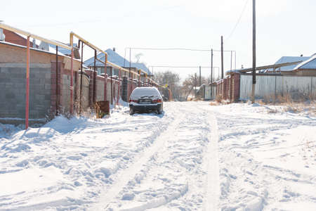 Car covered with snow in the yardの写真素材
