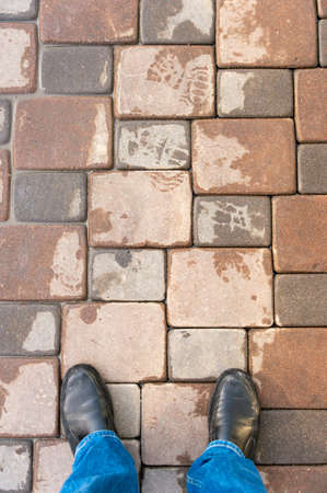 Man's feet walking down the sidewalkの写真素材