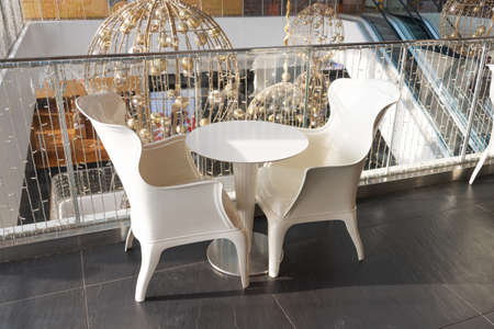 White chairs in a supermarket for customers to drink coffee and relaxの写真素材