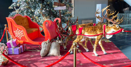 Christmas, New Year's interior, decorated Christmas tree with garlands and balls and the figure of a deerの写真素材