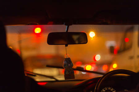 Inside a car with bokeh cork lights at night for backgroundの写真素材