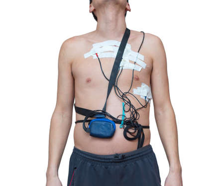 A man wears a Holter device, a device for daily ECG monitoring. Treatment of heart defectsの写真素材