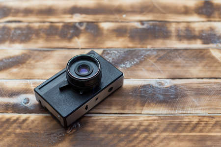 Retro camera on wood table background, vintage color toneの写真素材