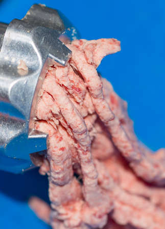 minced fresh beef goes through the meat grinder
