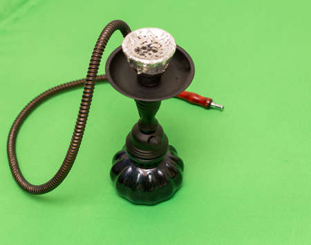 Black hookah on a green background