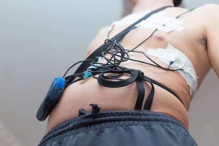 A man wears a Holter device, a device for daily ECG monitoring. Treatment of heart defectsの写真素材