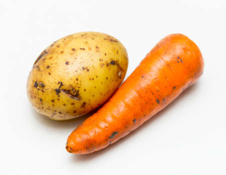 potatoes and carrots on white backgroundの写真素材