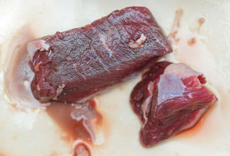 slices of raw meat on a white backgroundの写真素材