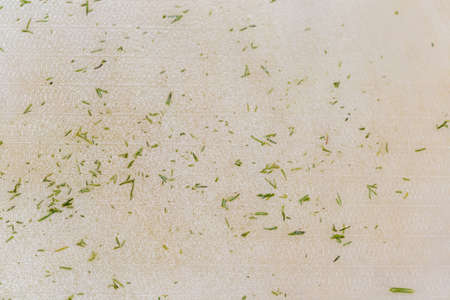 background, finely chopped green dill on a kitchen boardの写真素材