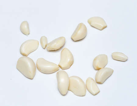 peeled garlic on a white backgroundの写真素材
