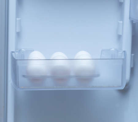 chicken eggs on a plastic tray in the fridgeの写真素材